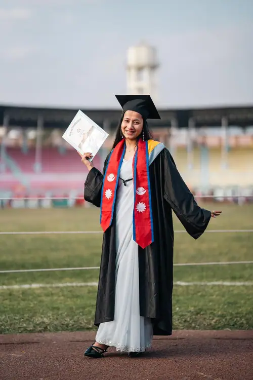 Kushum in graduation gown at the stadium